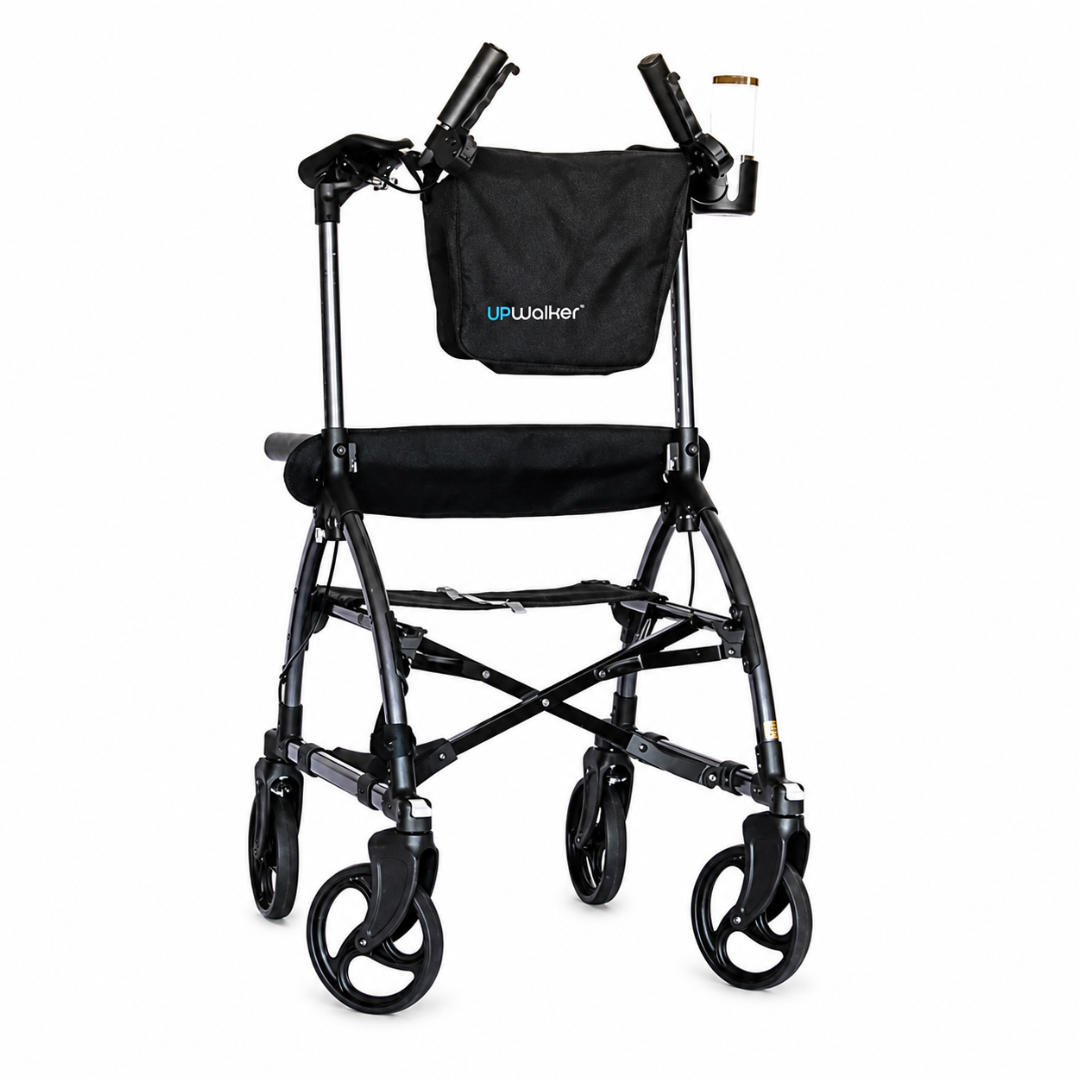 A black Journey UPWalker® Original Upright Rolling Walker Rollator featuring four wheels, a padded seat, upright arm supports, and a storage pouch attached to the front.